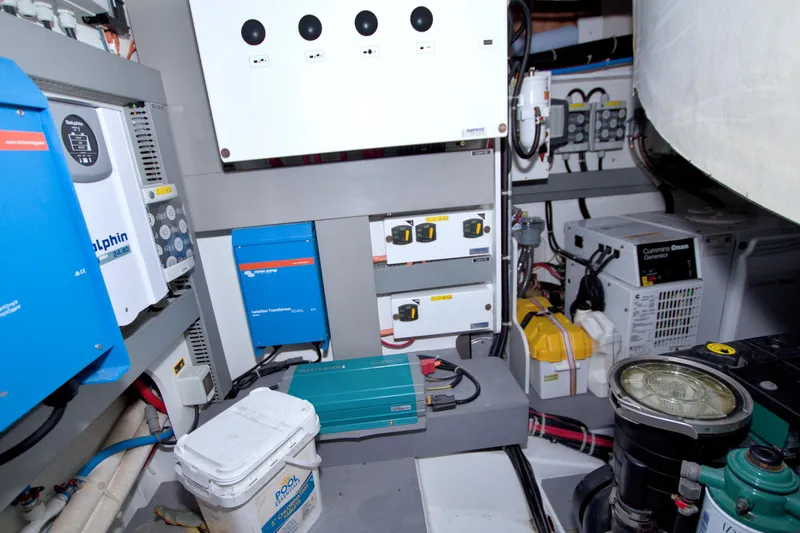 Slide: The Image of Engine room of 2019 Beneteau Gran Turismo 50 with electrical equipment and generator. - 78