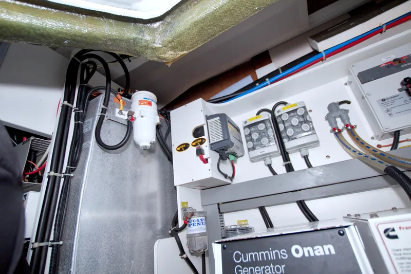 Slide: The Image of Engine room of 2019 Beneteau Gran Turismo 50 with Cummins Onan generator and electrical components. - 81