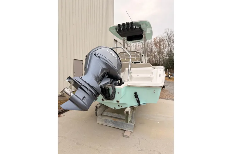 Slide: The Image of 2026 Key West 219 FS boat with Yamaha outboard motor, docked outdoors. - 2