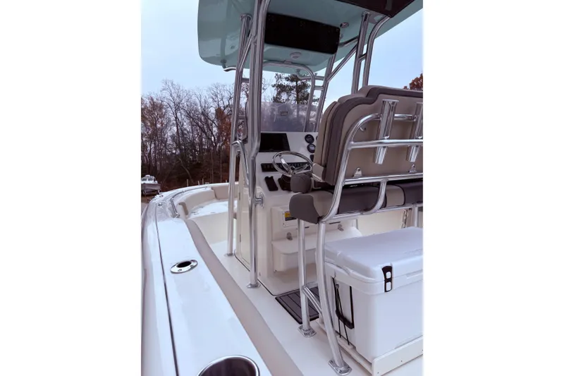 Slide: The Image of 2026 Key West 219 FS boat interior with helm, seating, and cooler. - 7