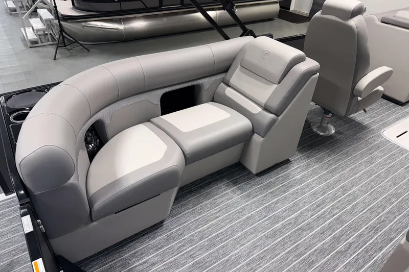 Slide: The Image of 2026 Premier 210 Sunsation RF Tritoon interior with gray seating and striped flooring. - 10