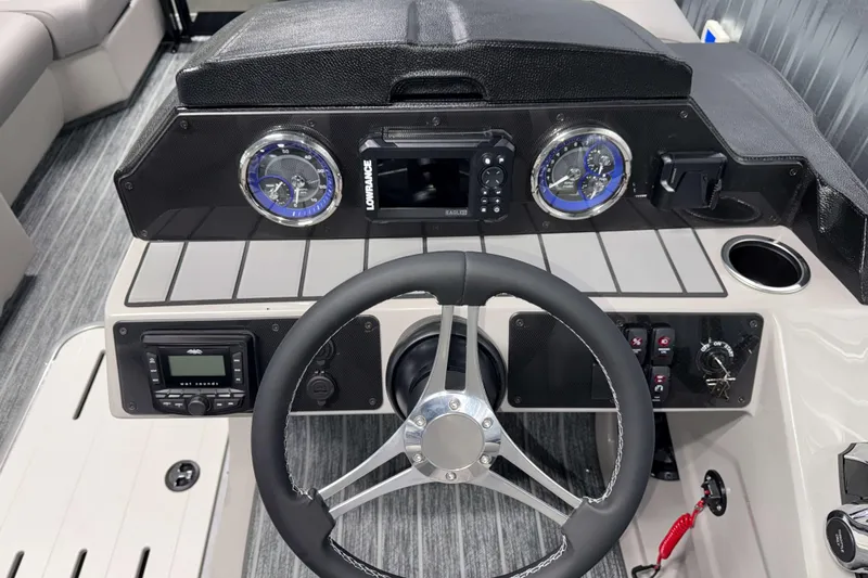 Slide: The Image of Steering console of 2026 Premier 210 Sunsation RF Tritoon with modern gauges and controls. - 12