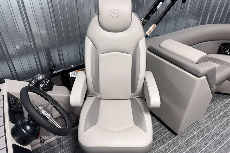 Slide: The Image of Captain's chair and helm of 2026 Premier 210 Sunsation RF Tritoon boat. - 14