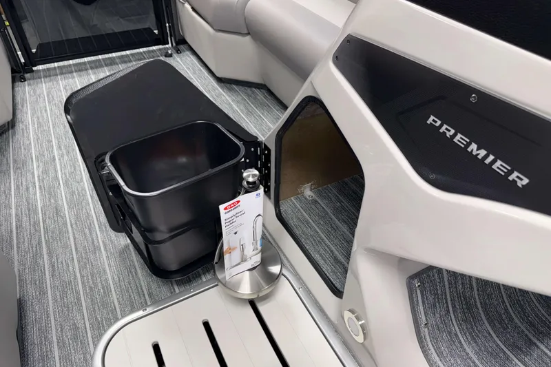 Slide: The Image of Interior of 2026 Premier 210 Sunsation RF Tritoon with storage compartment and accessories. - 15