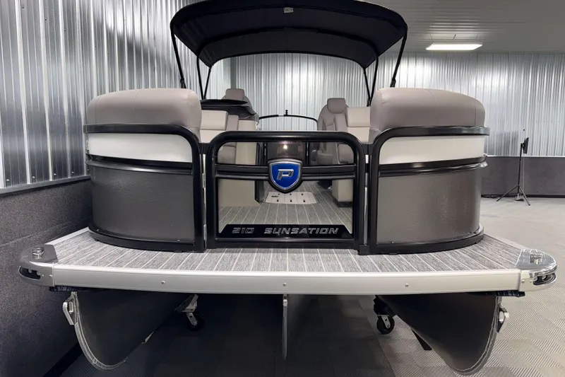Slide: The Image of 2026 Premier 210 Sunsation RF Tritoon boat in showroom, front view. - 2