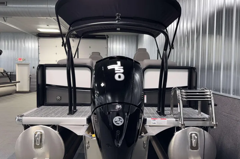 Slide: The Image of 2026 Premier 210 Sunsation RF Tritoon with powerful outboard motor in a sleek indoor setting. - 6