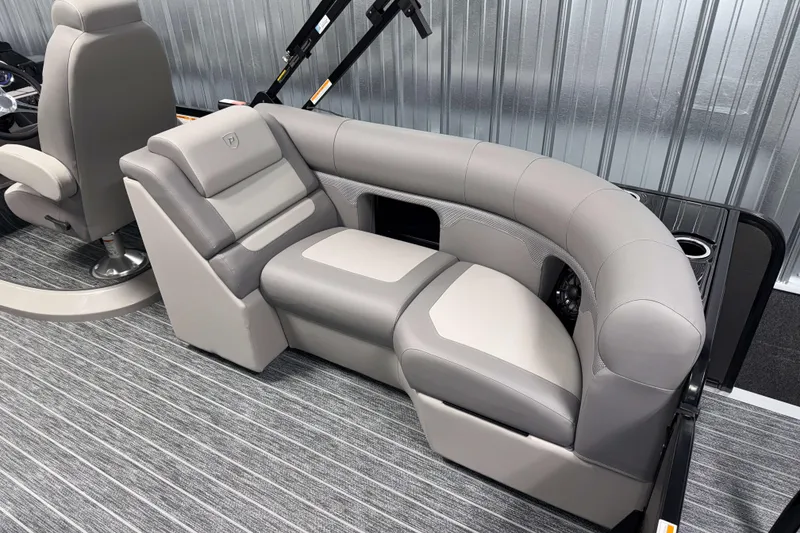 Slide: The Image of Luxurious seating in 2026 Premier 210 Sunsation RF Tritoon boat, featuring sleek gray upholstery. - 9