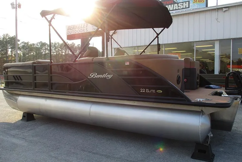 Slide: The Image of 2026 Bentley Pontoons Elite 223 Admiral pontoon boat with canopy, parked outdoors. - 1