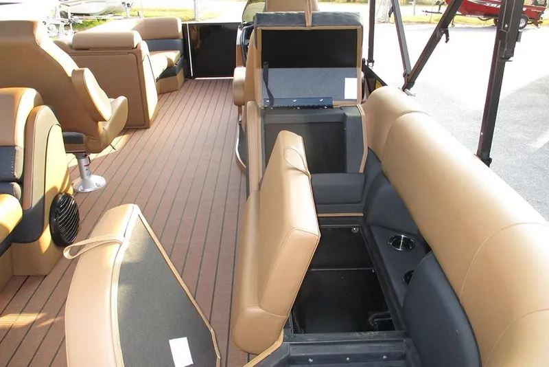 Slide: The Image of 2026 Bentley Pontoons Elite 223 Admiral interior with tan seating and storage compartments. - 22