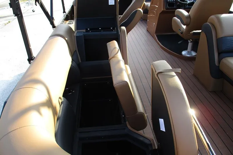 Slide: The Image of 2026 Bentley Pontoons Elite 223 Admiral interior with tan seating and storage compartments. - 27