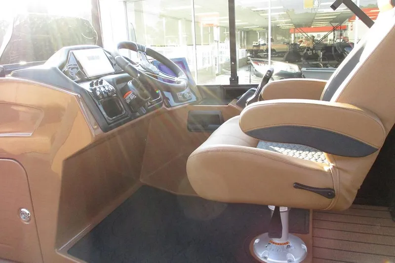 Slide: The Image of 2026 Bentley Pontoons Elite 223 Admiral helm with luxurious captain's chair and control panel. - 31