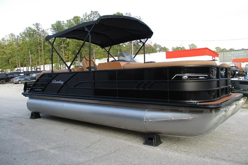 Slide: The Image of 2026 Bentley Pontoons Elite 223 Admiral, black pontoon boat with canopy, parked outdoors. - 4