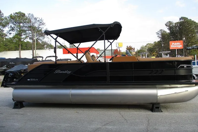 Slide: The Image of 2026 Bentley Pontoons Elite 223 Admiral pontoon boat with canopy, parked outdoors. - 5