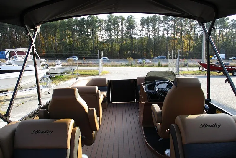 Slide: The Image of 2026 Bentley Pontoons Elite 223 Admiral interior with luxurious seating and steering console. - 8