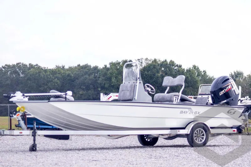 The Image of 2026 G3 Bay 21 GX boat on trailer, featuring sleek design and powerful engine. - 1