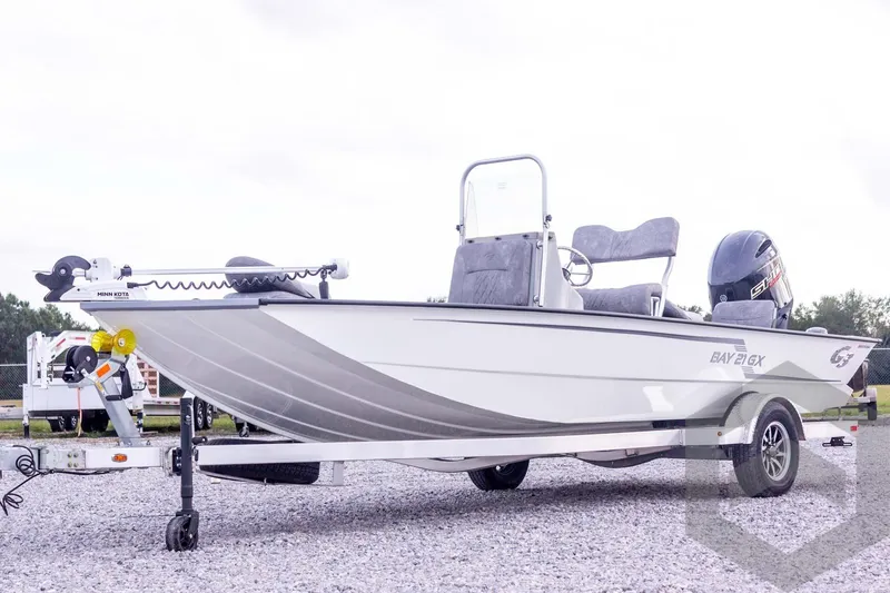 Slide: The Image of 2026 G3 Bay 21 GX boat on trailer, featuring Minn Kota trolling motor. - 10