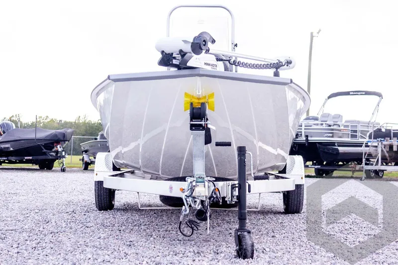 Slide: The Image of 2026 G3 Bay 21 GX boat on trailer, front view, parked on gravel lot. - 11