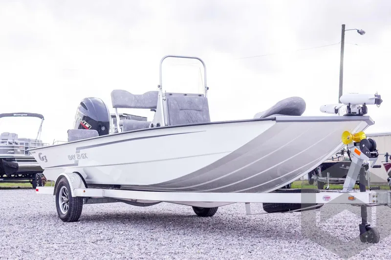 Slide: The Image of 2026 G3 Bay 21 GX boat on trailer, displayed outdoors on gravel. - 13