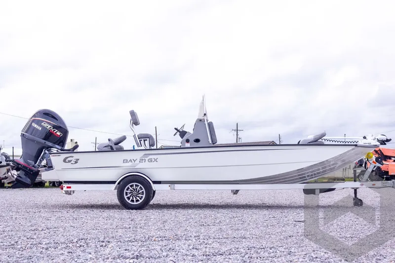 Slide: The Image of 2026 G3 Bay 21 GX boat with Yamaha engine on a trailer, parked outdoors. - 14