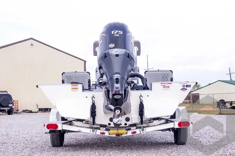 Slide: The Image of 2026 G3 Bay 21 GX boat with 175 HP engine on trailer, rear view. - 16