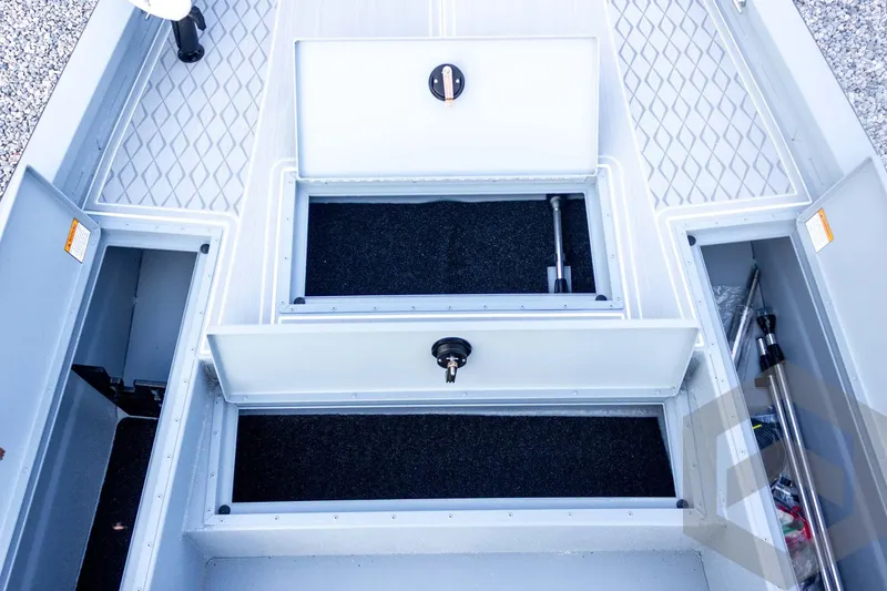 Slide: The Image of 2026 G3 Bay 21 GX boat storage compartments with open hatches and organized interior. - 28