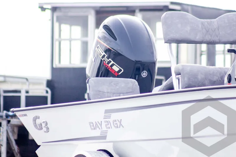 Slide: The Image of 2026 G3 Bay 21 GX boat with Yamaha outboard motor, docked near a building. - 3