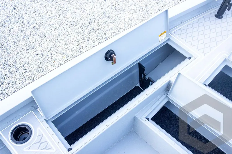 Slide: The Image of 2026 G3 Bay 21 GX boat storage compartments with cup holder, open for viewing. - 30