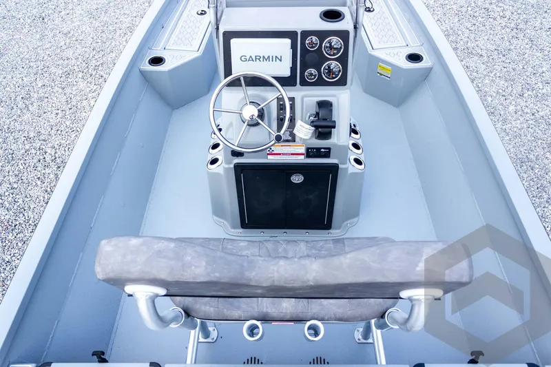 Slide: The Image of 2026 G3 Bay 21 GX boat console with Garmin display and steering wheel. - 43