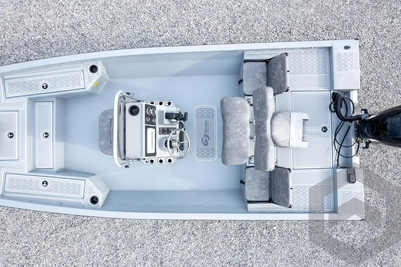 Slide: The Image of 2026 G3 Bay 21 GX boat interior with steering console and seating, top view. - 56