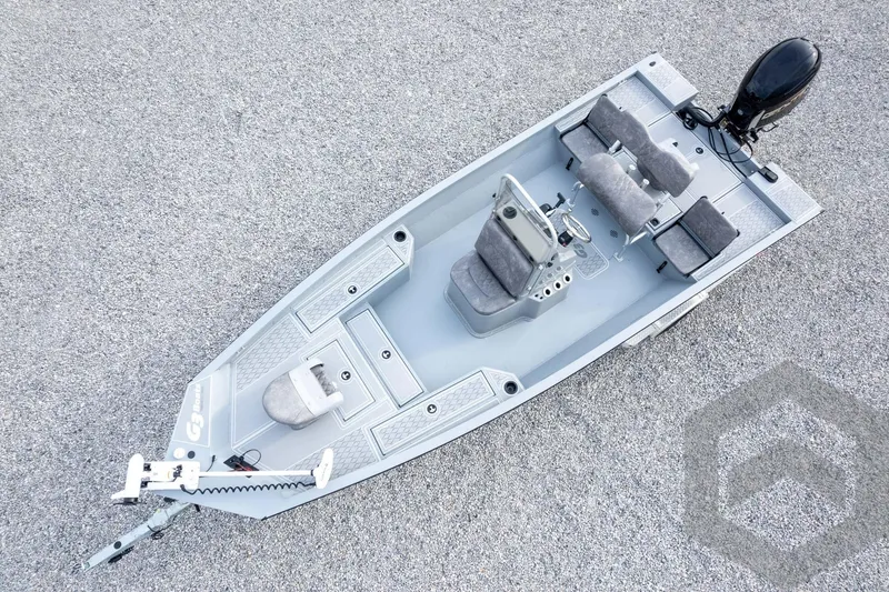Slide: The Image of 2026 G3 Bay 21 GX boat with seating and motor, viewed from above on gravel. - 58