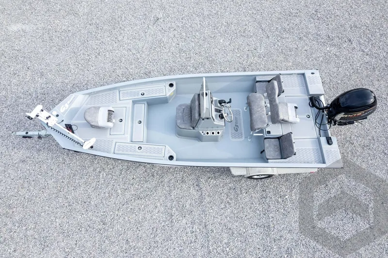 Slide: The Image of 2026 G3 Bay 21 GX boat, aerial view, featuring seating and motor on gravel surface. - 59