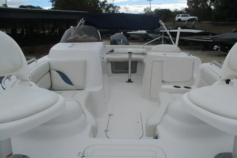 Slide: The Image of 2012 Starcraft 2009 OB Limited boat interior with white seating and open deck layout. - 3