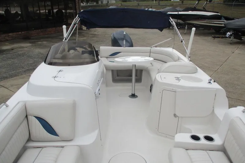 Slide: The Image of 2012 Starcraft 2009 OB Limited boat interior with seating and canopy, docked outdoors. - 7