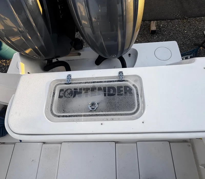 Slide: The Image of 2024 Contender 25 Tournament CC boat with dual engines and branded livewell. - 12