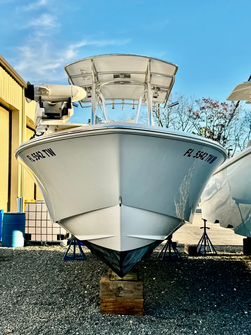 Slide: The Image of 2024 Contender 25 Tournament CC boat on display, front view with clear sky background. - 2