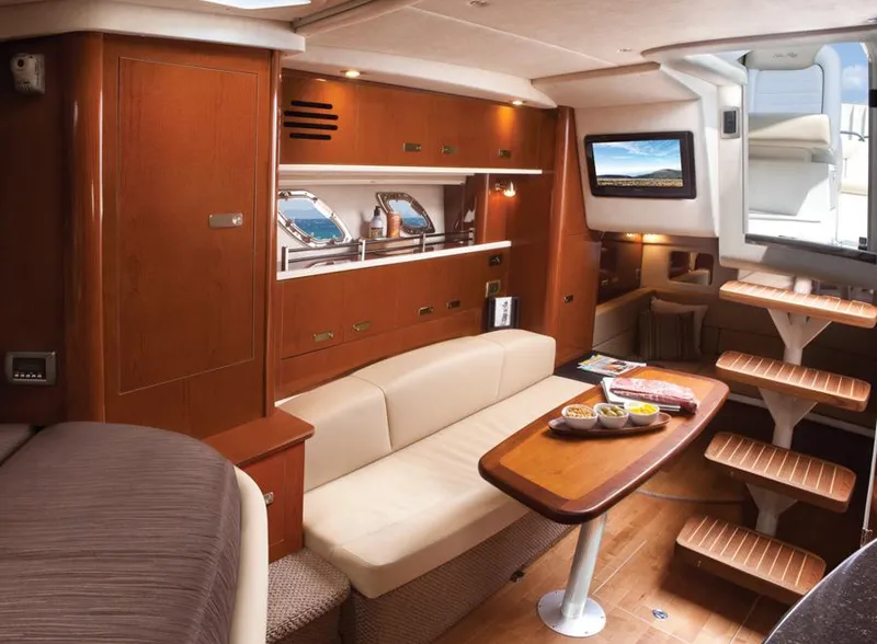 Slide: The Image of Manufacturer Provided Image: Interior of 2012 Sea Ray 330 Sundancer yacht with wooden cabinetry and cozy seating. - 14