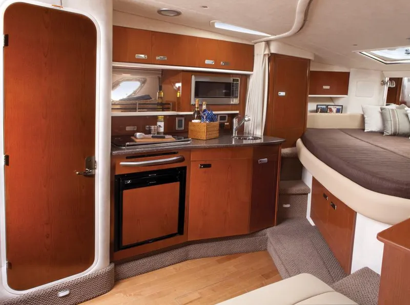 Slide: The Image of Manufacturer Provided Image: Interior of 2012 Sea Ray 330 Sundancer yacht with kitchenette and sleeping area. - 16