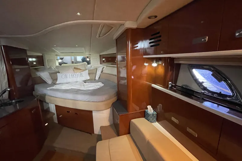 Slide: The Image of Luxurious interior of 2012 Sea Ray 330 Sundancer yacht with cozy bed and elegant wood finish. - 18