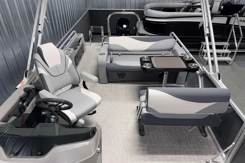 Slide: The Image of 2026 Avalon LSZ 2385 Entertainer boat interior with seating and steering area. - 16