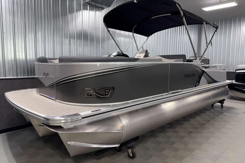 Slide: The Image of 2026 Avalon LSZ 2385 Entertainer pontoon boat in showroom, sleek design, metallic finish. - 20