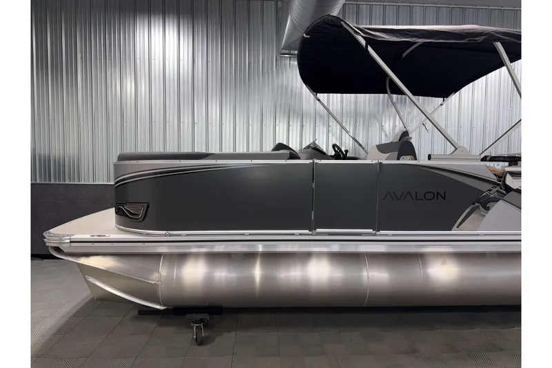 Slide: The Image of 2026 Avalon LSZ 2385 Entertainer pontoon boat with sleek design and canopy. - 23