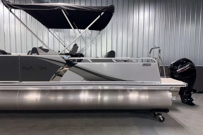 Slide: The Image of 2026 Avalon LSZ 2385 Entertainer pontoon boat with Mercury outboard motor in showroom. - 25