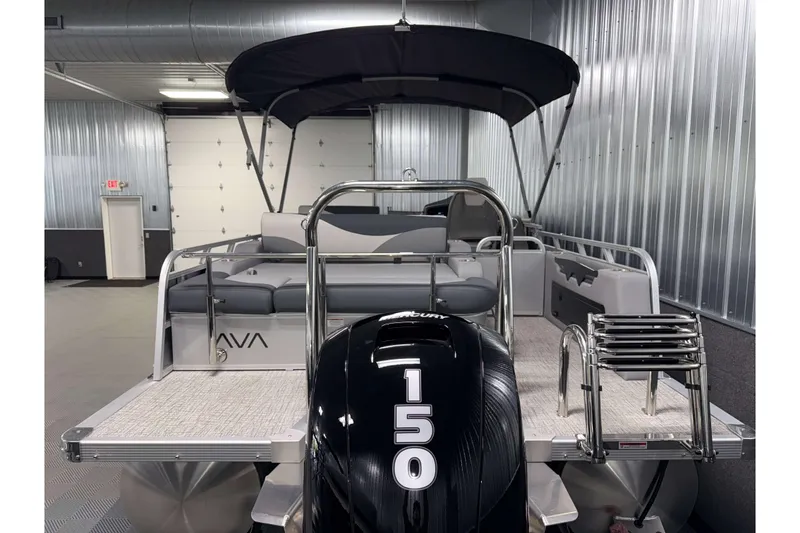 Slide: The Image of 2026 Avalon LSZ 2385 Entertainer pontoon boat with Mercury 150 engine in a metal garage. - 27