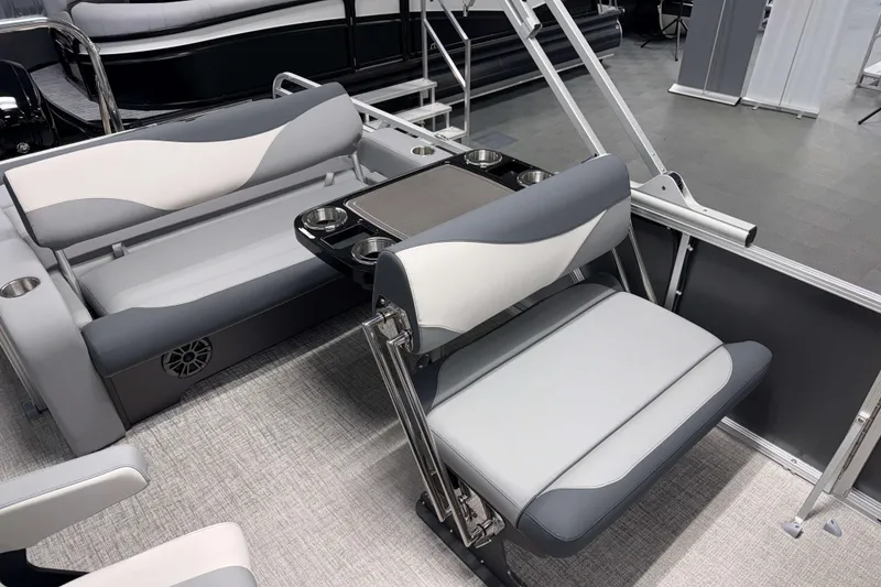 Slide: The Image of 2026 Avalon LSZ 2385 Entertainer pontoon boat interior with stylish seating and table setup. - 7