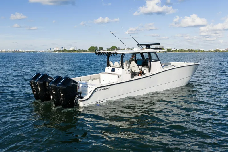 Slide: The Image of 2022 Freeman 43 boat on calm water under blue sky with clouds. - 13