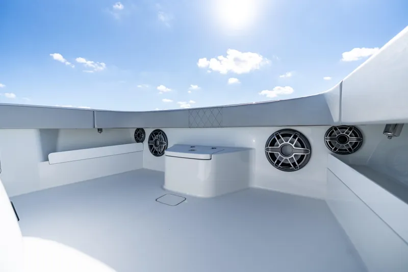 Slide: The Image of 2022 Freeman 43 boat interior with speakers and seating under a clear blue sky. - 20