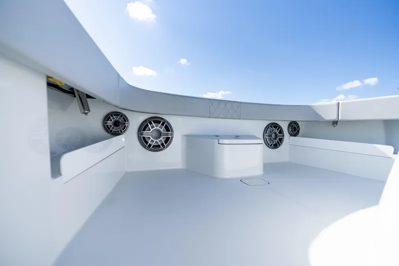 Slide: The Image of 2022 Freeman 43 boat interior with rod holders and speakers under blue sky. - 21