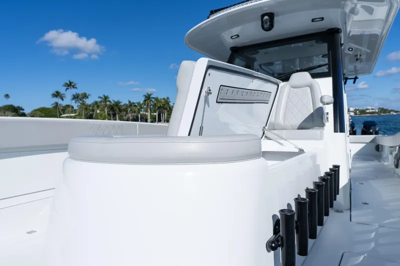 Slide: The Image of 2022 Freeman 43 boat interior with open storage compartment and rod holders. - 23