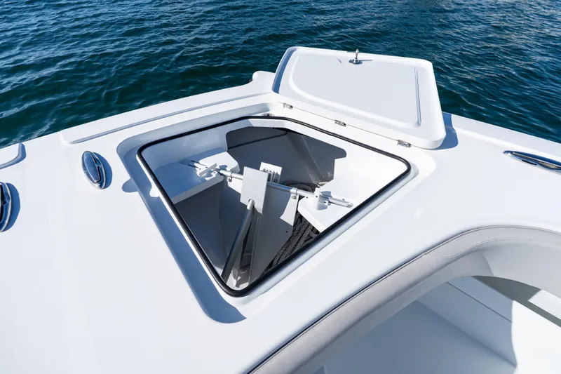 Slide: The Image of Freeman 43 boat deck with open storage compartments, 2022 model, on calm water. - 26
