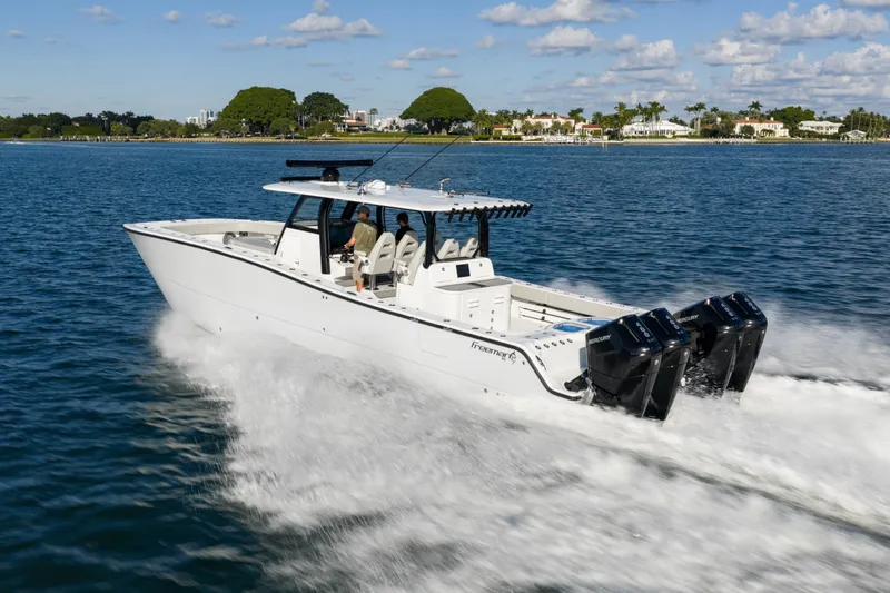 Slide: The Image of 2022 Freeman 43 boat cruising on water under a partly cloudy sky. - 5